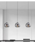 Modern Dine Dining Room Pendant Lights Indoor Lighting Ceiling Lamp hanging over a sleek black dining table.