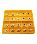 Front view of yellow plastic organizer holding 20 diamond-shaped carbide turning inserts with center holes.