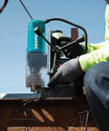 Makita HB350 1-3/8 inch magnetic drill; front view with teal body being used on a metal beam