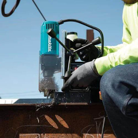 Makita HB350 1-3/8 inch magnetic drill; front view with teal body being used on a metal beam
