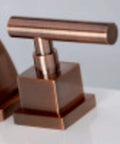 Close-up of Claremont Mini Widespread Lavatory Faucet handle in polished chrome, showcasing solid brass construction.