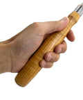 Hand holding Heavy Duty Chrome Vanadium Paring Chisel With Cryogenic Treated Edge and Long Comfort Grip for wood carving.
