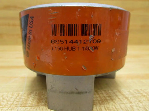 Close-up of L-1501.125 jaw coupling with barcode and 1.125 inch bore, for torque transfer in industrial gearboxes.