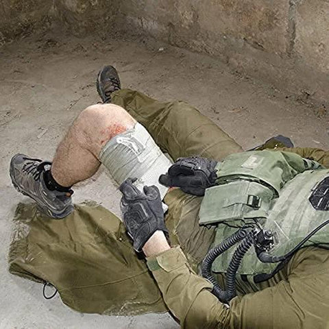 Rhino Rescue 6-inch Israeli-style emergency bandage applied to injured leg of person in tactical gear