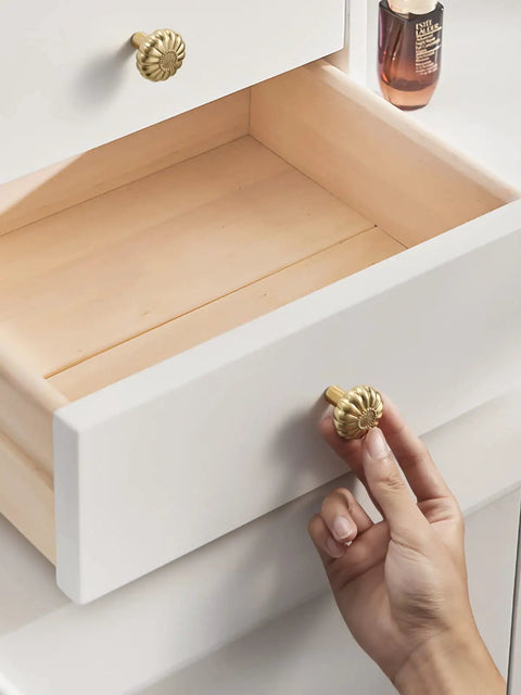 Hand installing Brushed Gold Cabinet Knob Set Five Pack Dope Brass Drawer Pulls for Kitchen Cupboard on white dresser.