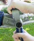 Heavy Duty Seven Pattern Firemans Hose Nozzle With Adjustable Pressure Rust Proof Yard Sprayer Tough As Nails For Garden Cleanup And Flushes Every Job Real Slick Like A Champ, hand gripping nozzle outdoors.