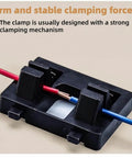 Pro Grade Wire Welding Fixture With Black Base And Bright Orange Helping Hands Clamp holding red and blue wires securely.