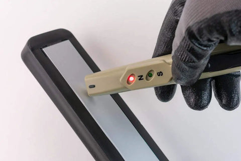 Gloved hand using AMY6 Magnetic Tester Blue With Easy To Use Pocket Clip And Pen Style Design Red And Green LED Visual Alerts