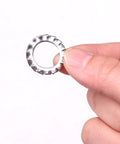 Stainless steel external-tooth star washer, close-up view.