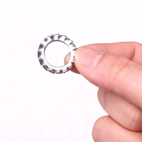 Stainless steel external-tooth star washer, close-up view.