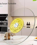 Large Tabletop Rotating Lazy Susan Turntable In Bright Yellow With Slick Silent Spin And Zero Drama Tempered Glass Build, shown on a kitchen countertop.