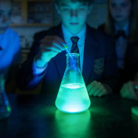 Students conducting science experiment with glowing liquid from 6 Grams Luminol Powder For 16 Oz Solution Lab Grade High Purity