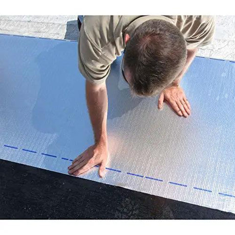 Heavy Duty Self Stick Roll Roofing Gray Waterproof Peel and Seal Tape for RV Trailer Homes Low Slope Pitch Roofs Killer Seal with 45 Mil Thickness being applied by hand on a roof.