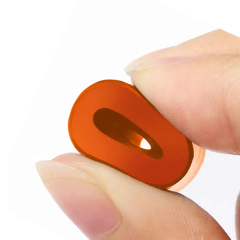 Close-up of an orange silicone bed mount held between fingers, featured in Upgrade Your Rig With Built Tough Silicone Bed Mounts And Heavy Duty Leveling Springs That Deliver Flawless Prints Every Single Time For Ender 3 Max Cr10 Sv01 Sv02 Fdm Printer Accessories.