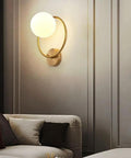 Modern Luxury Sphel Glass lampshade Wall Sconce 9.0 Inch Width den Iron Body Wall Lamp with 3 Color Mode Indoor Lighting Fixture for Bedroom Living Room Study Hallway on a beige wall.