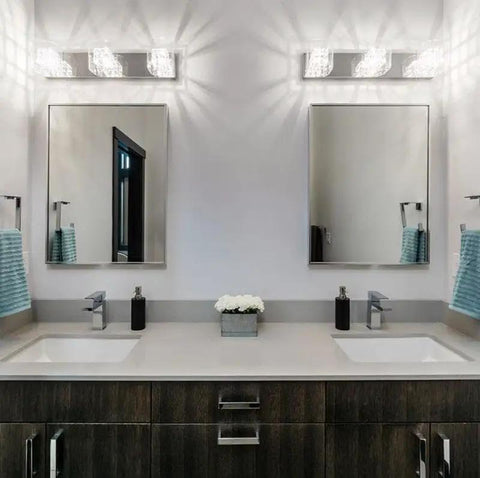 Modern bathroom with two mirrors, stylish lighting, gray countertop, and white vessel sink on dark cabinetry.