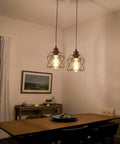 Sleek Matte Black Farmhouse Pendant Light Bringing Modern Industrial Vibe To Your Kitchen Island Or Dining Room Ceiling Hanging Fixture Quick Room Glow Up That Hits Different over a dining table.