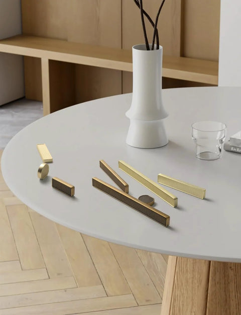 Assorted handles on table, featuring Six Pack Antique Brass Finger Pulls For Cabinets And Drawers, Solid Zinc Alloy Hardware.