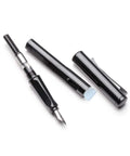 Dismantled black fountain pen with cap, clip, and nib on white background
