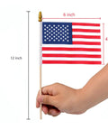 Hand holding Six Pack 4x6 Inch Small American Flags On Wooden Sticks Handheld USA Flags With Kid Safe Spear Top and size details