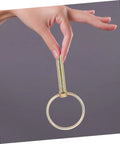 Hand holding a clevis pin and safety pin from the 12 Piece Heavy Duty Clevis Pin And Safety Pin Kit With Hitch Ring Clips For Secure Fastening.