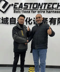 Two professionals shaking hands in front of EASTONTECH sign, discussing Precision Rotary Wire Stripping Machine that eats 8mm2 cables.
