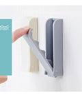 Slick Foldable Wall Hooks Self Adhesive Space Savers For Hats Bathrobes Coats Heavy Duty Peel Stick Easy Install shown in use.
