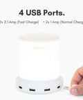Touch Activated Nightstand Lamp With 4 USB Ports For Fast Charging, 3 Way Dimmable, shown with cables and ports in small space setup