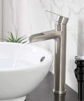 Vessel Sink Faucet With Waterfall Spout In Brushed Nickel Finish Single Handle 1 Hole Vanity Faucet Tall Lavatory Faucet With Pop Up Drain Solid Brass Construction Includes Two Three Eighth Inch Hoses For RV Or Home displaying water flow next to a white vessel sink and pop-up drain