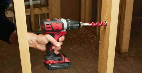 Heavy Duty 18 Volt Cordless Rig Showcasing A Boss Level Half Inch Drill drilling into wood with an auger bit, demonstrating durability.