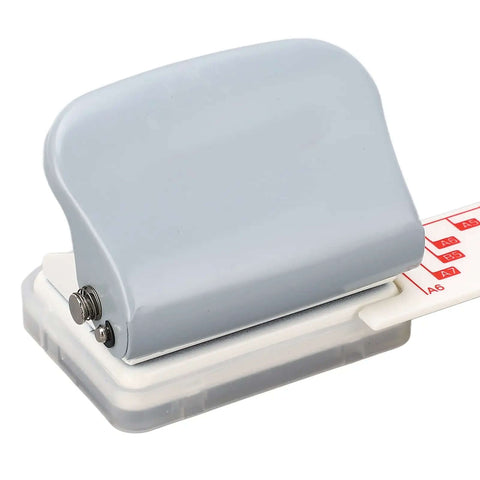 Portable Handheld 3 Hole Paper Puncher With 5 Sheet Capacity in gray, built tough with all metal construction, showing close-up of design and ruler.