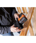 Person holding Green Laser Level Kit with Self Leveling 5 Dot GreenBrite Technology showing magnetic base use on job site.