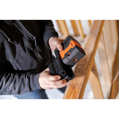 Person holding Green Laser Level Kit with Self Leveling 5 Dot GreenBrite Technology showing magnetic base use on job site.