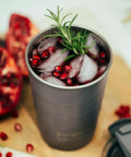 Close-up of 16 Oz Triple Vacuum Insulated Stackable Tumbler With Leak Proof Screw Top Lid featuring ice and pomegranate seeds.