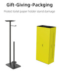 Floor Standing Toilet Paper Holder Dispenser With Four Roll Storage And Top Shelf For Phone Wipes And Wallet Rust Resistant Stainless Steel Black Finish next to yellow box packaging