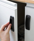 Person using Self Stick Instant Cabinet Drawer Handle Multipurpose Stick On Handle for easy opening on kitchen cabinet