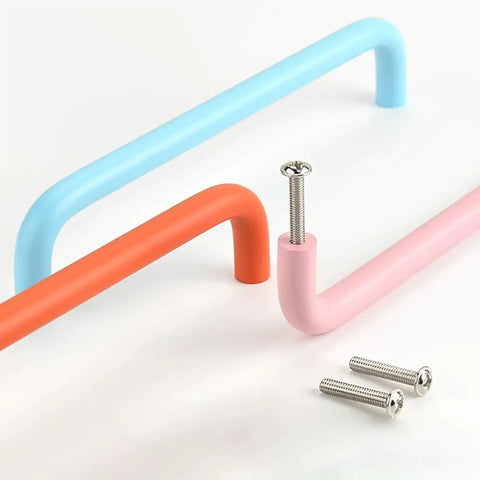 Colorful cabinet pull handles with screws, showcasing pastel blue, orange, and pink curved designs with visible mounting screws.