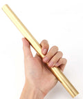 Two Pack 1 Inch Diameter Brass Rod Lathe Bar 12 Inch Length Brass Bar Stock held in hand, ideal for DIY crafts and model making.