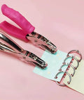 No Fuss Easy Grip One Quarter Inch Hole Punch With Scraps Tray Round Circle Punch showing pink handle and binder rings in use