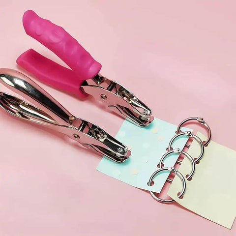 No Fuss Easy Grip One Quarter Inch Hole Punch With Scraps Tray Round Circle Punch showing pink handle and binder rings in use