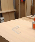 Eight Pack Silicone Window Corner Protectors for safety and injury prevention on a wooden table in a workshop setting