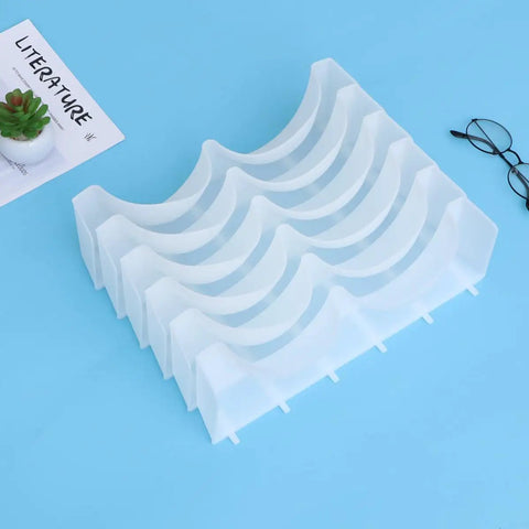 Six Piece Clear Plastic Bra Storage Box With Dividers For Wardrobe Closet Drawer Organization To Keep Lingerie Lineup Hella Neat And Shielded From Deformation A Straight Up Must Have Staple on blue background.
