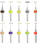 10 tungsten carbide drill bits, 0.1mm to 1.0mm, for PCB use, arranged showing symmetrical cutting edges with colored rings.