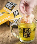 Disposable Loose Leaf Tea Filters For Easy Brewing, Unbleached Paper Sachets used in glass mug, 100 Empty Bags displayed