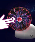 Plasma Ball Essential STEM Tool For Curious Minds A 5 Inch Glass Sphere With An Awesome Interactive Electric Light Show Learn Electricity Matter And Energy Through A Sound Activated High Voltage Neon Glow. 5-inch glass plasma ball on white base, hand touch shown