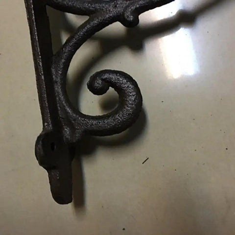Hella Sturdy Rock Solid Cast Iron Wall Mounted Corner Support Brackets With A Killer Vintage Floral Design For That Top Shelf Rustic Industrial Home Decor Look, detailed close-up view.