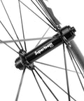 Close-up of Carbon Fiber Road Bike Wheelset 700C Clincher hub showing spokes and matte finish.