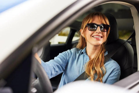 ZEISS Pre Moistened Sunglasses Cleaning Wipes 240 Count, woman wearing black sunglasses in a car, denim shirt.
