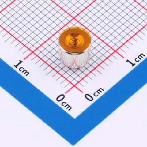 Single M2x4 copper tinned SMD round nut on grid, part of 20 Pcs Smd Round Nut Circuit Board Surface Mount Column Pcb Connector M2x4 Copper Tinned Built Tough Pro Grade Straight Up Quality No Fuss Reliable Hardware For Quick Diy Fixes And Rapid Assembly Jobs.