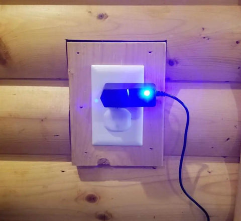 Six Foot 9V AC DC Power Adapter For Roland Boss RC 3 Loop Station plugged into wooden wall outlet with glowing blue light